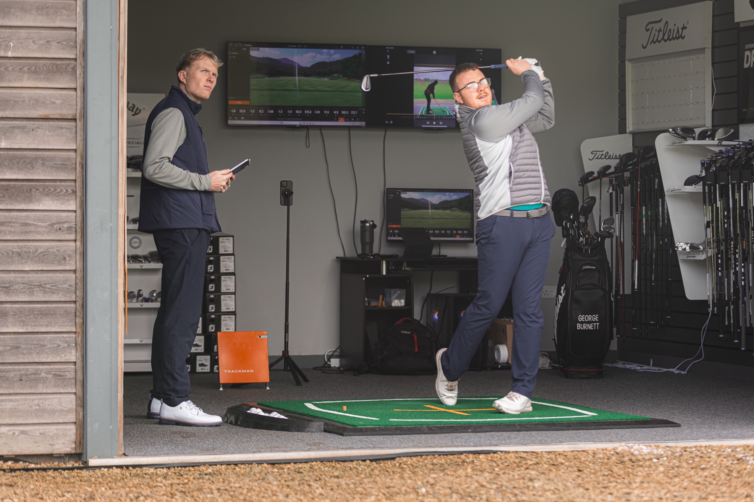 George Burnett coaching a golfer in the studio