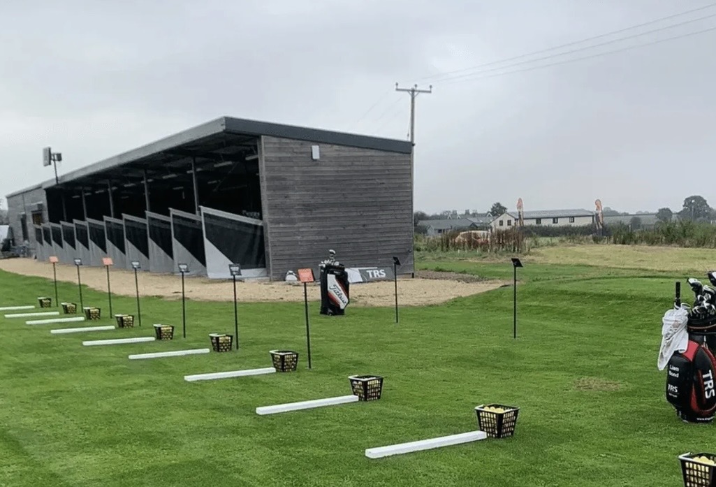 Grass practice tees alongside the covered range